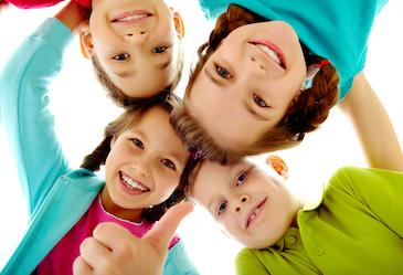 group of four children hugging | childrens dentistry teaneck nj