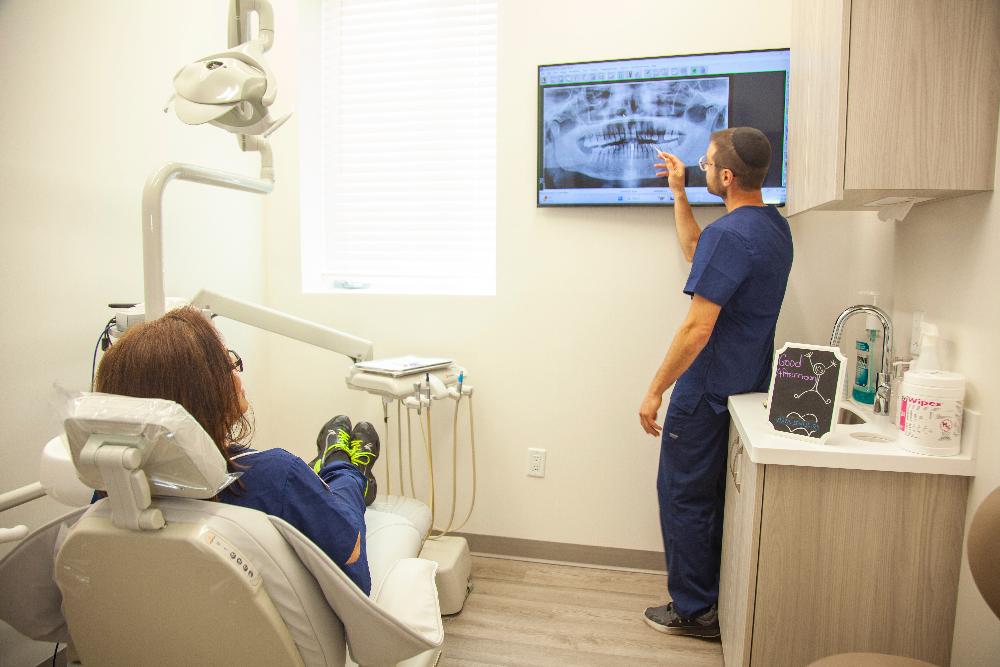 dr eli looking at dental x-ray | cosmetic dentistry teaneck nj