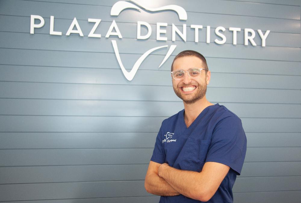 dr eli in front of plaza dentistry sign | invisalign teaneck nj