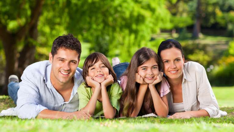 family of four on grass | teaneck dentist