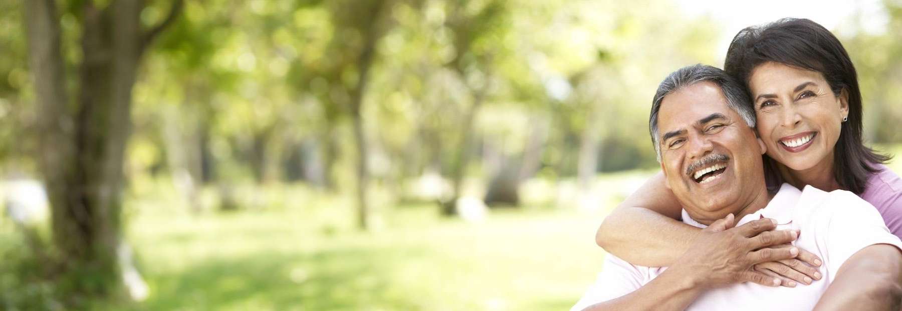couple laughing outside | teaneck dentist