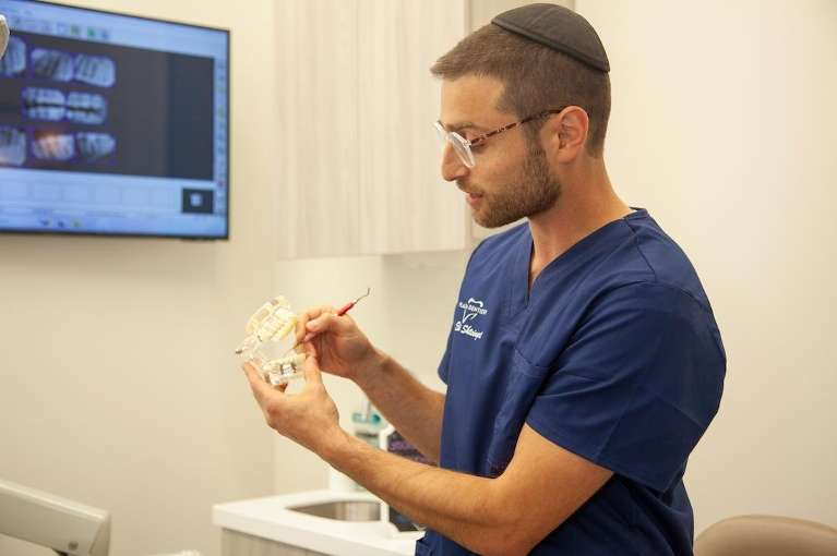 dr eli shteingart holding jaw impression | dentist teaneck new jersey